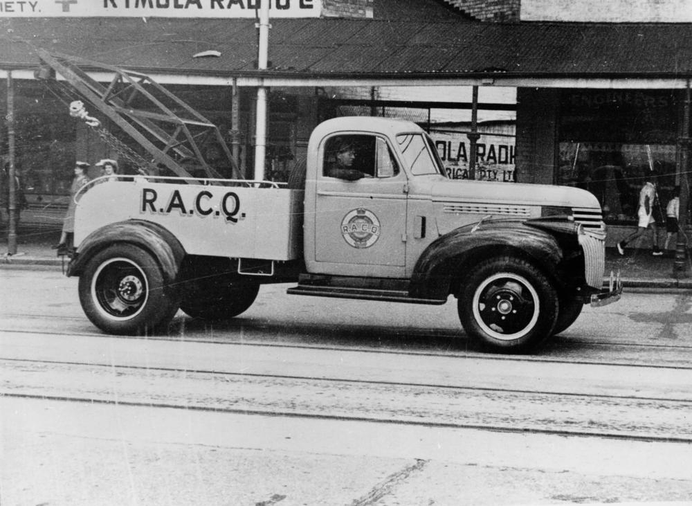 Tow truck assisting a stranded car after a breakdown