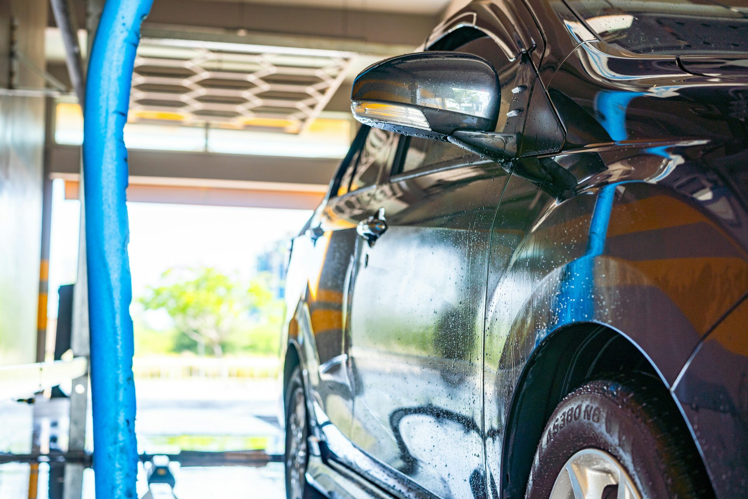 Car at a wash bay or cleaning site as an alternative to washing at home