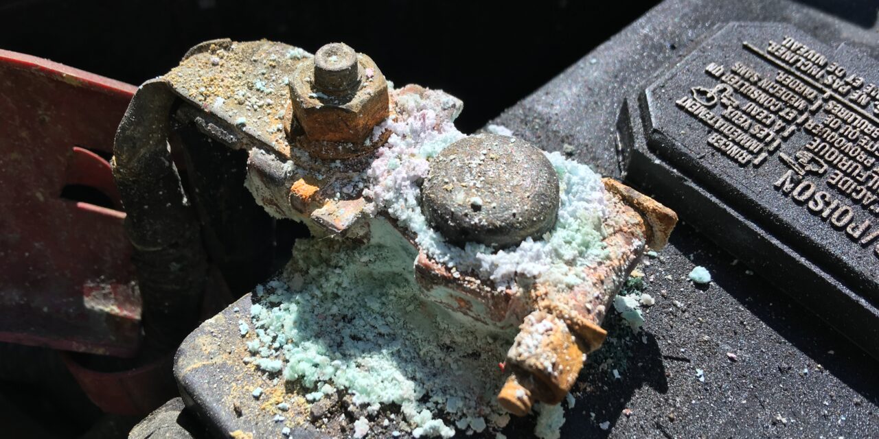 White powder on a car battery terminal: clean it safely, then find the cause