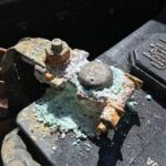 White powder on a car battery terminal: clean it safely, then find the cause