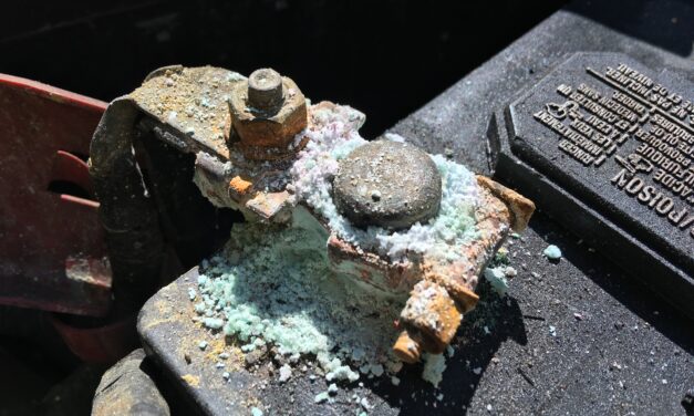 White powder on a car battery terminal: clean it safely, then find the cause
